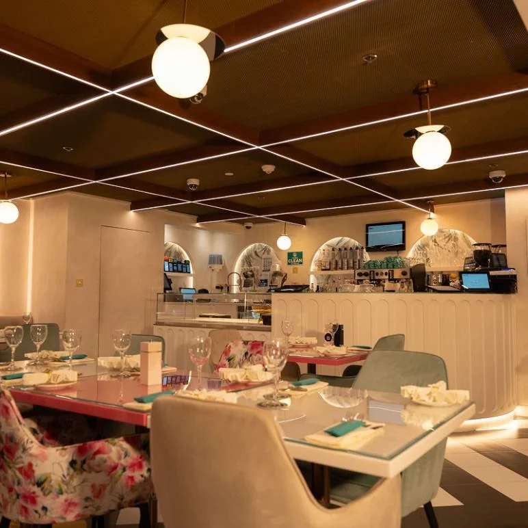 The white and pink interior of a restaurant 
