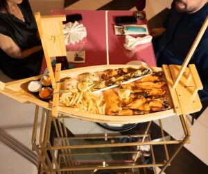 Elegant seafood platter served in a wooden boat-shaped tray at Villamoura Dubai