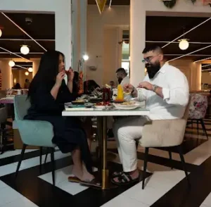 Couple dining at Villamoura, where to eat langoustines in Dubai, on Sheikh Zayed Road